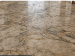 Marble floor before restoration showing dull, uneven patches under natural light